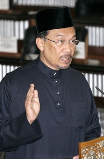 Malaysian opposition leader Anwar Ibrahim swears in at Parliament house in Kuala Lumpur, Malaysia, Thursday, Aug. 28, 2008. Anwar took his place Thursday as a member of Malaysia's Parliament, a major step in his goal to topple the government weakened by electoral defeats and internal dissent.