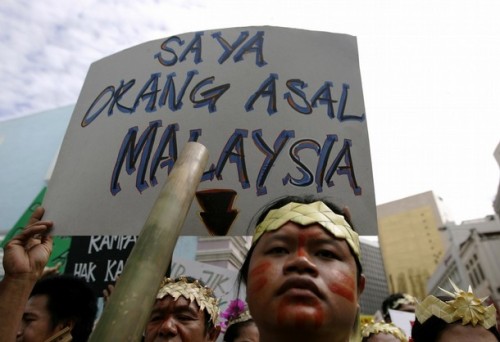 An indigenous Malaysian holds a placard saying "I am an original inhabitant of Malaysia" during a demonstration to call for the government to implement the individual and collective rights of indigenous people, in Kuala Lumpur September 13, 2008.