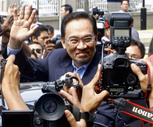 Malaysian opposition leader Anwar Ibrahim waves to his supporters outside the Sessions Court in Kuala Lumpur on September 10, 2008. Anwar was in court to face a sodomy charge similar to one filed against him a decade ago and which he claim as politically motivated. The case was postpone until September 24.      AFP PHOTO / KAMARUL AKHIR (Photo credit should read KAMARUL AKHIR/AFP/Getty Images)