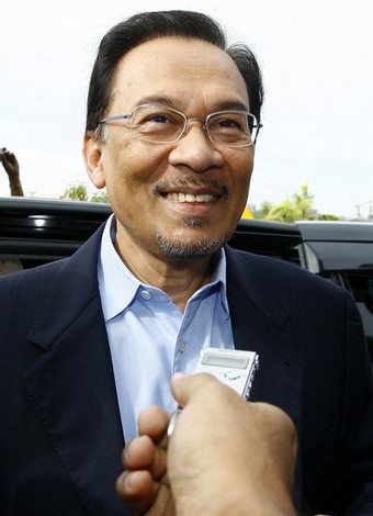 Malaysian opposition leader Anwar Ibrahim smiles as he arrives at the court house in Kuala Lumpur on September 10, 2008. Anwar was in court to face a sodomy charge similar to one filed against him a decade ago and which he claim as politically motivated. The case was postponed until September 24.