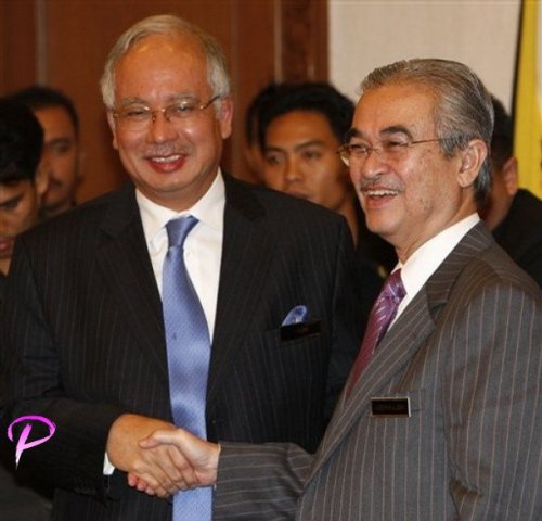 Malaysia's Prime Minister Abdullah Ahmad Badawi, right, greets by his deputy Najib Razak after a press conference in Kuala Lumpur, Wednesday, Oct. 8, 2008. Malaysia's embattled prime minister announced Wednesday he will step down in March and hand over power to his deputy, four years before his term ends.