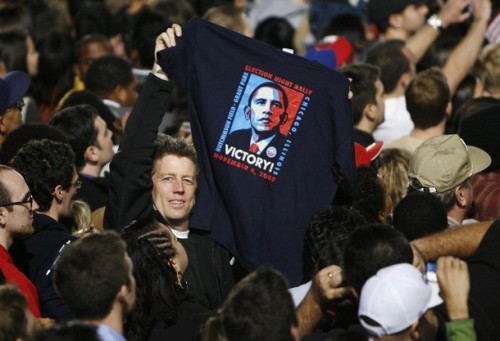 A supporter of U.S. President-elect Senator Barack Obama (D-IL) holds up an Obama t-shirt during his election night rally in Chicago November 4, 2008. Obama captured the White House on Tuesday after an extraordinary two-year campaign, defeating Republican John McCain to make history as the first black to be elected U.S. president.
