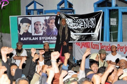 Brother of the two convicted 2002 Bali bombers Amrozi and Mukhlas, Jafar Shodiq (C, standing) shouts "God is great" along with supporters, at Al Islam boarding school in Tenggulun in the early morning of November 9, 2008 as they hear news that the three Bali bombers have been executed. Three Islamists sentenced to death for the Bali bombings which killed 202 people were executed by firing squad at midnight, local television reported. Amrozi, 47, his brother Mukhlas, 48, and ringleader Imam Samudra, 38, were killed with shots to the heart on the island prison of Nusakambangan off southern Java, TV One television reported quoting an official source.