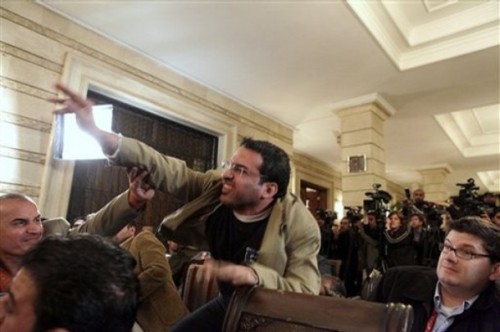 An Iraqi man throws a shoe at President George W. Bush during a new conference with Iraq Prime Minister Nouri al-Maliki on Sunday, Dec. 14, 2008, in Baghdad. A man threw two shoes at Bush, one after another, during the news conference. Bush ducked both throws, and neither man was hit. (AP Photo/Evan 