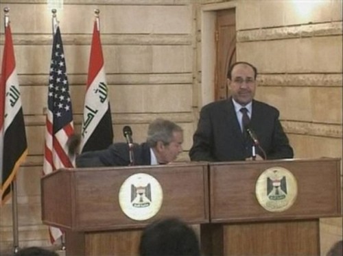 In this image from APTN video, US President George W. Bush, left, ducks as a man throws a shoe at him, during a news conference with Iraq Prime Minister Nouri al-Maliki, Sunday, Dec. 14, 2008, in Baghdad, Iraq. On an Iraq trip shrouded in secrecy and marred by dissent, President George W. Bush on Sunday hailed progress in the war that defines his presidency and got a size-10 reminder of his unpopularity when a man hurled two shoes at him during a news conference. (AP Photo)