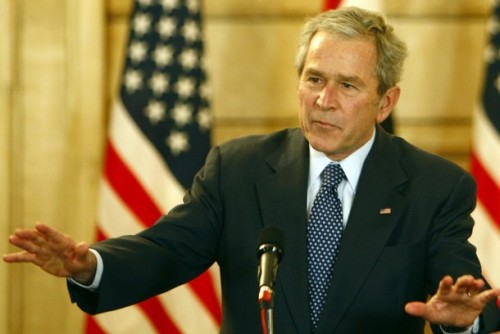 U.S. President George W. Bush reacts to calm down after a shoe was thrown at him by an Iraqi reporter during a joint press conference with Iraqi Prime Minister Nuri al-Maliki (unseen) in Baghdad December 14, 2008. President George W. Bush made an unannounced farewell visit to Baghdad today, just weeks before he leaves his office to President-elect Barack Obama.  AFP PHOTO/ Thaier al-Sudani -POOL (Photo credit should read THAIER AL-SUDANI/AFP/Getty Images)