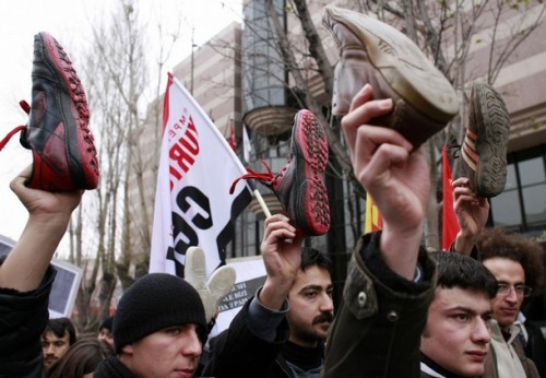 Leftist protesters display shoes as they protest in front of the U.S. Embassy in Ankara December 18, 2008. Turkey's Communist Party members organized the rally to protest against the U.S. and to support Iraqi journalist Muntazer al-Zaidi, who hurled his shoes at U.S. President George W. Bush during a news conference in Iraq on December 14, 2008. REUTERS/Umit Bektas (TURKEY)