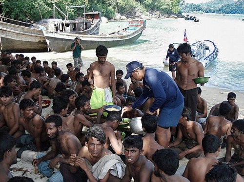 This undated handout photo released by Thai Royal Navy on January 20, 2009 shows illegal immigrants from Bangladesh and Myanmar receiving food on the beach after they were escorted by Thai navy to Similan island south of Thailand.  Thailand's army chief said January 20, 2009 that the military followed humanitarian principles when dealing with boat people from Myanmar whom they stand accused of mistreating, a security spokesman said. Survivors and a human rights group have accused the Thai army and navy of detaining and beating up to 1,000 members of a Rohingya minority from Myanmar late last year, before towing them out to sea with little food and water. AFP PHOTO/Thai Royal Navy/HO  RESTRICTED TO EDITORIAL USE (Photo credit should read AFP/AFP/Getty Images)
