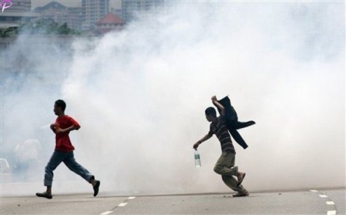 Protesters run away from tear gas fired by Malaysian riot police during a protest against the use of English to teach math and science in Kuala Lumpur, Malaysia, Saturday, March 7, 2009. AP Photo