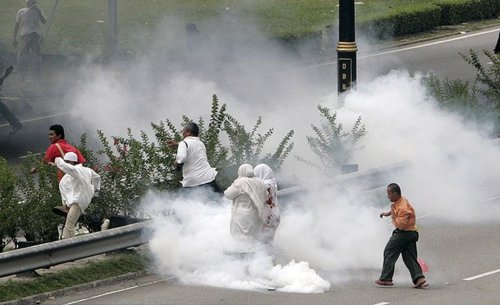 Protesters run from tear gas during a demonstration against the use of the English language in teaching science and mathematics at schools, in Kuala Lumpur. - Photo Reuters