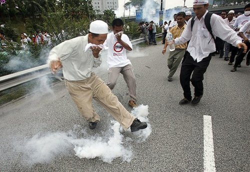 A protester kicks a tear gas canister during a demonstration against the use of the English language in teaching science and mathematics at schools, in Kuala Lumpur March 7, 2009. Malaysian police fired tear gas to disperse hundreds of opposition activists demanding that science and math be taught in the national Malay language, witnesses said. Language is a sensitive issue for the country's majority Malays and represents the latest political battleground for incoming Prime Minister Najib Razak, who is already facing a challenge from a weakening economy.    REUTERS PICTURES