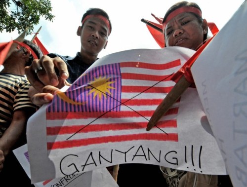Indonesians hold up pictures of the Malaysian flag as well as other placards, saying "ganyang" or attack, during an anti-Malaysia protest in Jakarta on August 30, 2009 after the neighbouring country was accused of using Indonesian traditional dances to promote Malaysian tourism.  Indonesian President Susilo Bambang Yudhoyono has asked the Malaysian government to deal more carefully with "sensitive" cultural issues between the two countries, after a recent Malaysian tourism advertisement, a 30-second video clip, showed Balinese "Pendet" dancing.   AFP PHOTO / Bay ISMOYO (Photo credit should read BAY ISMOYO/AFP/Getty Images)