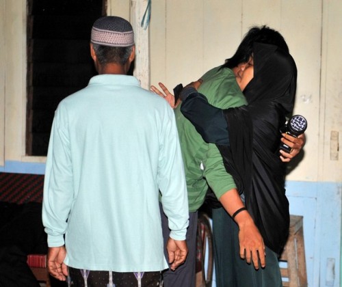 CAPTION ADDITION -- The son (C) of the convicted 2002 Bali bomber Amrozi, Mahendra is comforted by relative at Al Islam boarding school in Tenggulun in the early morning of November 9, 2008 as they hear news that the three Bali bombers have been executed. Three Islamists sentenced to death for the Bali bombings which killed 202 people were executed by firing squad at midnight, local television reported. Amrozi, 47, his brother Mukhlas, 48, and ringleader Imam Samudra, 38, were killed with shots to the heart on the island prison of Nusakambangan off southern Java, TV One television reported quoting an official source. AFP PHOTO/ADEK BERRY (Photo credit should read ADEK BERRY/AFP/Getty Images)
