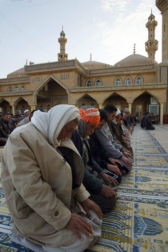 Iraqi Muslim Sunni men take part in the early morning prayers marking the start of Eid al-Adha in the northern city of Kirkuk, 255 kms from the capital Baghdad on December 08, 2008. The Eid marks the end of the Muslim pilgrimage or Hajj in the holy city of Mecca in Saudi Arabia. AFP PHOT