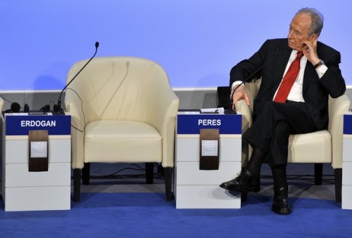 Israeli President Shimon Peres listens near the empty seat of Turkish Prime Minister Recep Tayyip Erdogan after Erdogan stormed out of a debate with  Peres about the Gaza war at the Davos forum on January 29, 2009.   AFP PHOTO FABRICE COFFRINI (Photo credit should read FABRICE COFFRINI/AFP/Getty Images)