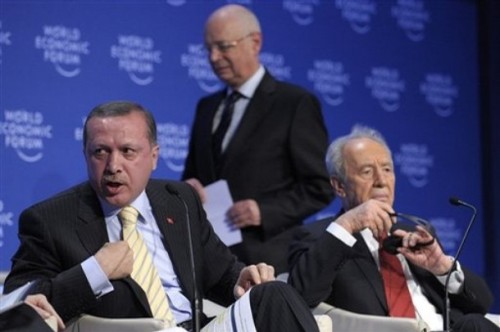 Recep Tayyip Erdogan, Prime Minister of Turkey, left, just before he leaves the stage in front of Shimon Peres, right, President of Israel and Swiss Klaus Schwab, founder and president of the World Economic Forum, WEF, during a plenary session on the Middle East Peace at the Annual Meeting of the World Economic Forum, WEF, in Davos, Switzerland, Thursday, Jan. 29, 2009. Turkish President Recep Tayyip Erdogan has later stalked off the stage at the World Economic Forum,  after verbally sparring over Gaza with Israeli President Shimon Peres.  (AP Photo/Keystone/Laurent Gillieron)